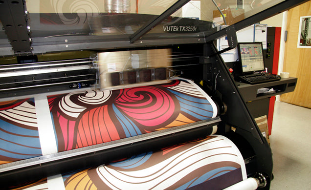 Large format sublimation printer with colourful print in a printing facility